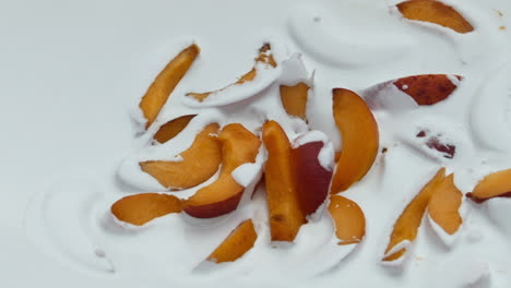 Fresh-yogurt-pieces-apricot-background-close-up.-Fruity-creamy-dairy-dessert.