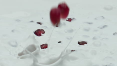Closeup-pomegranate-splashing-milk-in-super-slow-motion.-Healthy-nutrition.