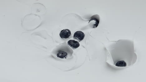 Ripe-blueberry-falling-yogurt-in-super-slow-motion-close-up.-Natural-breakfast