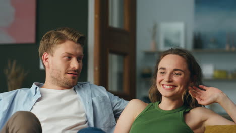 Closeup-laughing-couple-resting-sofa-home.-Cheerful-carefree-spouses-having-fun