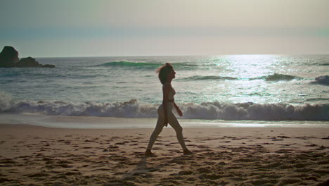 Woman-walking-sand-seashore-enjoying-summer-sunrise-vertical-video.-Girl-going