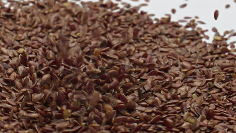Heap-flax-seeds-falling-on-creamy-surface-dairy-dessert-close-up.-Healthy-food.