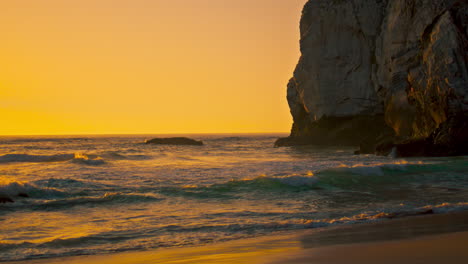 Stone-cliffs-sunrise-beach-water-surface-vertically-oriented-view.-Ocean-waves
