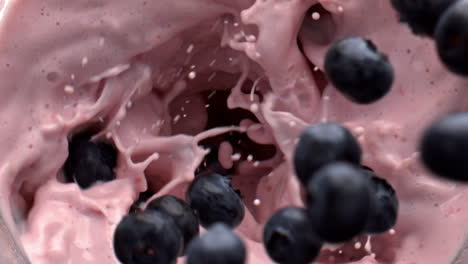 Berries-tossing-whirlpool-milkshake-top-view.-Adding-ingredients-in-beverage
