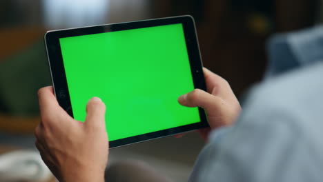 Gamer-hands-playing-mockup-tablet-at-room.-Closeup-man-tapping-greenscreen-pad