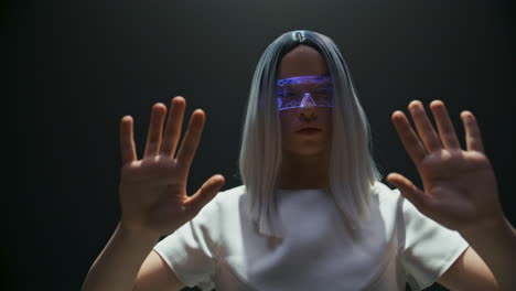 Cyber-girl-play-simulation-game-in-vr-glasses-closeup.-Futuristic-player-touch