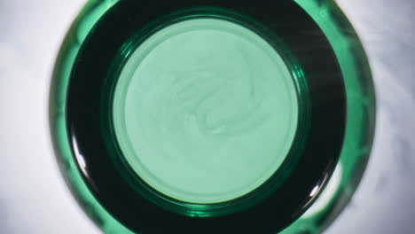 Craft-drink-opened-flask-top-view.-Hoppy-fresh-beer-in-green-vessel-closeup