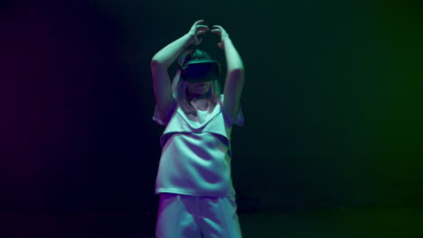 Futuristic-woman-dancing-neon-cyberspace-in-vr-glasses.-Happy-gamer-enjoying
