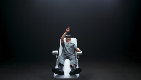 Nano-technologies-gamer-immersed-VR-dark-room.-Man-enjoying-haptic-gloves-chair