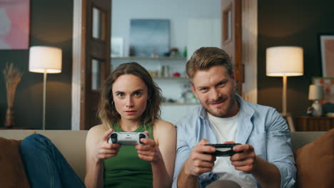 Focused-friends-holding-controllers-playing-game-at-home-pov.-Couple-videogame