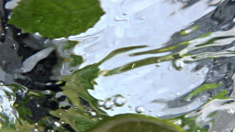 Fizzy-mint-cocktail-rotating-inside-clean-glass-closeup.-Vitamin-water-spinning