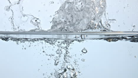 Pear-splashed-fizzy-water-closeup.-Fresh-yellow-fruit-fall-under-bubbles-liquid