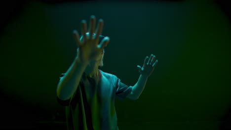 Vr-player-dancing-neon-lights-room.-Happy-gamer-enjoying-metaverse-simulation-in