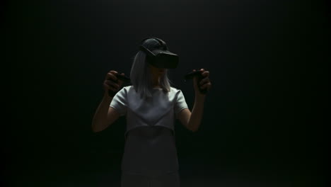 Fashionable-girl-playing-vr-game-in-blinking-light.-Futuristic-gamer-experience