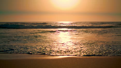 Beautiful-foamy-waves-sunrise-beach-vertical-view.-Yellow-sundown-empty-seashore