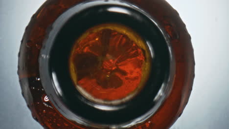 Golden-ipa-splashing-flask-top-view.-Closeup-inebriant-liquid-bubbling-in-bottle