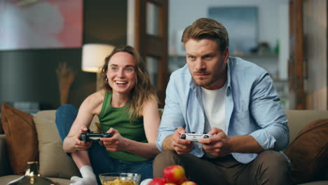 Active-friends-playing-console-game-comfy-house.-Excited-couple-trying-to-win