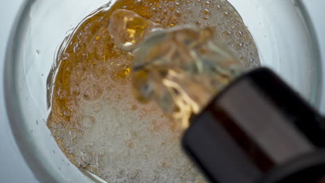 Lager-drink-filling-vessel-closeup.-Bottled-cold-craft-beverage-pouring-glass