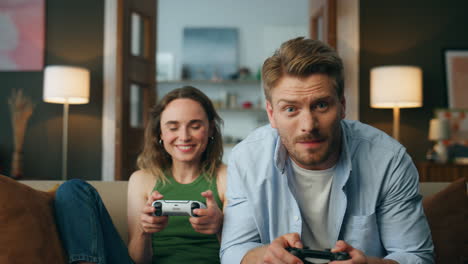 Pov-couple-playing-console-game-at-evening-house.-Excited-active-pair-video-game