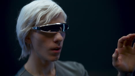 Digital-glasses-man-travelling-metaverse-outer-space.-Gamer-gesturing-touching