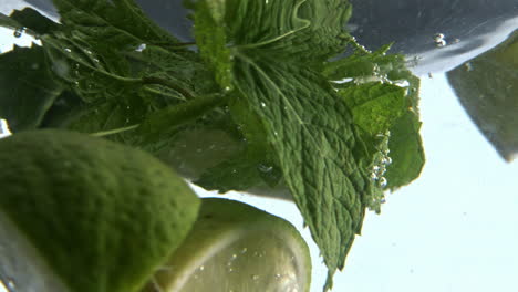 Refreshing-lime-beverage-whirlpool-closeup.-Mojito-drink-swirling-moving-glass
