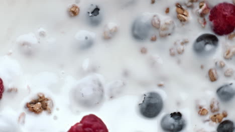 Raspberry-throwing-splashing-yoghurt-top-view.-Calcium-oat-liquid-with-berries