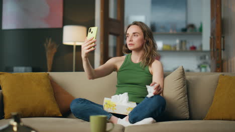 Unhappy-girl-speaking-phone-holding-napkin.-Sad-woman-trying-calm-online-therapy