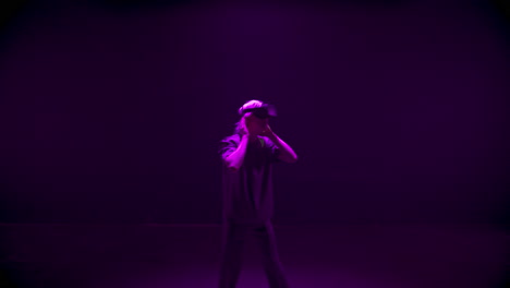 Man-exploring-virtual-reality-in-neon-lights.-Focused-gamer-looking-around-in