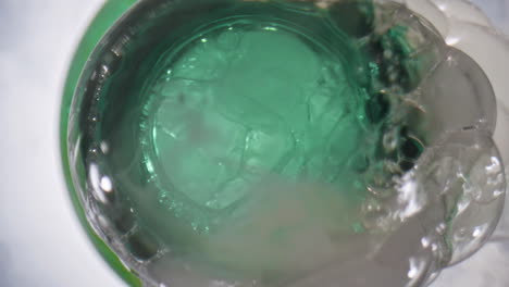 Chilled-beer-foaming-bottle-closeup.-Hoppy-liquor-frothing-out-of-opened-flask