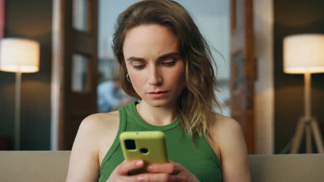 Focused-lady-messaging-smartphone-at-home-zoom-on.-Closeup-woman-texting-phone