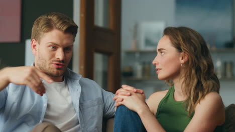 Emotional-man-telling-story-to-wife-home-closeup.-Serious-lovers-talking-sofa
