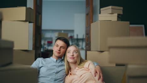 Newlyweds-moving-new-flat-enjoying-own-property-closeup.-Couple-sitting-on-couch