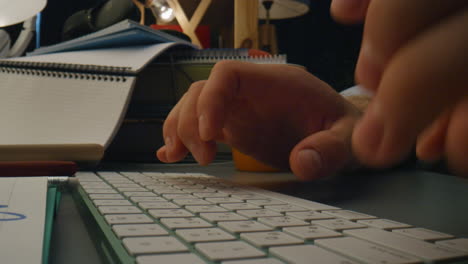 Unknown-guy-typing-device-at-evening-zoom-on.-Man-arms-pressing-computer-buttons