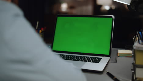 Unrecognizable-guy-watching-mockup-laptop-home.-Man-reading-green-screen-closeup