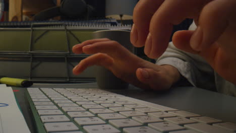 Woman-arms-pressing-buttons-at-night-closeup.-Unknown-girl-typing-computer