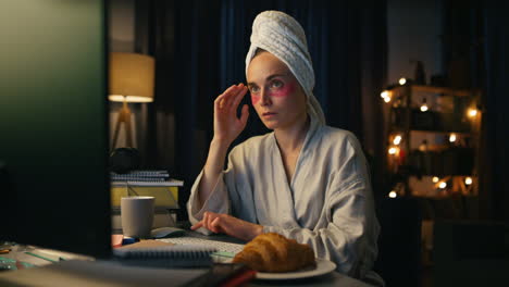 Bathrobe-freelancer-reading-pc-home-closeup.-Serious-woman-watching-computer