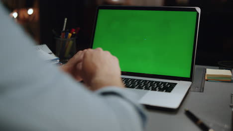 Anonymous-man-typing-chromakey-laptop-at-home-closeup.-Guy-using-mockup-device
