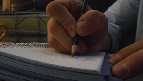 Guy-arms-writing-pencil-table-closeup.-Unknown-person-preparing-schedule