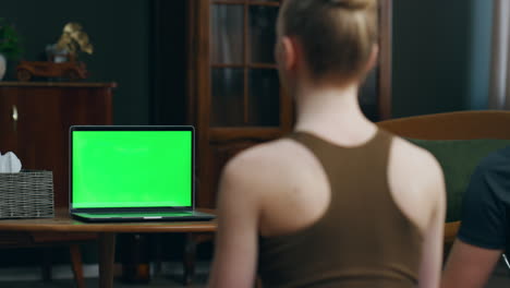 Woman-watching-mockup-laptop-in-room-close-up.-Girl-looking-on-online-lesson.