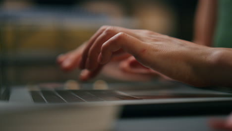 Lady-hands-texting-laptop-buttons-dark-interior-macro-view.-Girl-fingers-typing