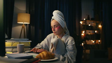Focused-woman-typing-computer-closeup.-Serious-bathrobe-lady-browsing-internet