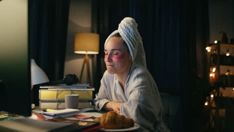 Closeup-freelancer-working-computer-late-at-night.-Smart-bathrobe-woman-smiling