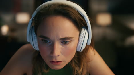 Worried-woman-looking-computer-at-home-closeup.-Headphones-lady-feeling-shocked