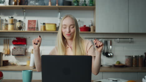 Woman-dancing-music-laptop-at-kitchen-closeup.-Woman-taking-break-in-remote-work