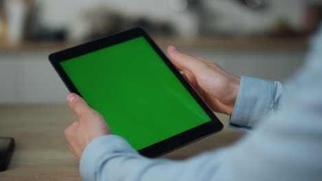 Hands-holding-mockup-tablet-close-up.-Guy-touching-green-screen-swiping-zooming.