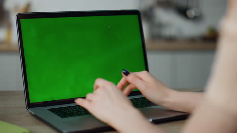 Woman-typing-green-screen-laptop-close-up.-Businesswoman-using-chroma-key-gadget