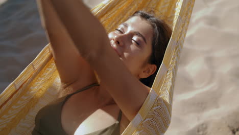 Calm-girl-lying-hammock-in-sunlight-closeup.-Carefree-beautiful-woman-relaxing