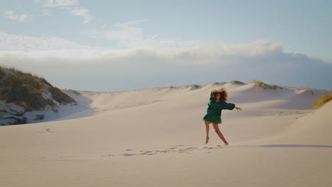 Brunette-artist-dancing-sand-dunes-at-summer.-Woman-moving-actively-at-desert.