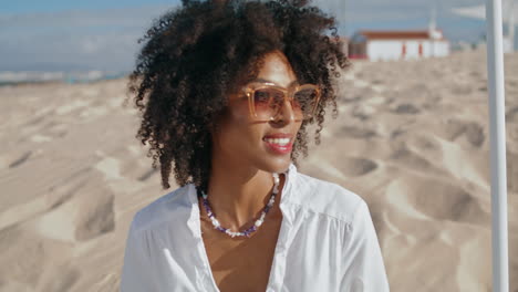 Stylish-woman-enjoy-beach-on-sunny-day-closeup-vertical.-Happy-african-american