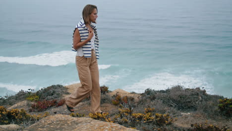 Tourist-walking-ocean-coast-in-summer-vertical.-Peaceful-girl-enjoying-waves